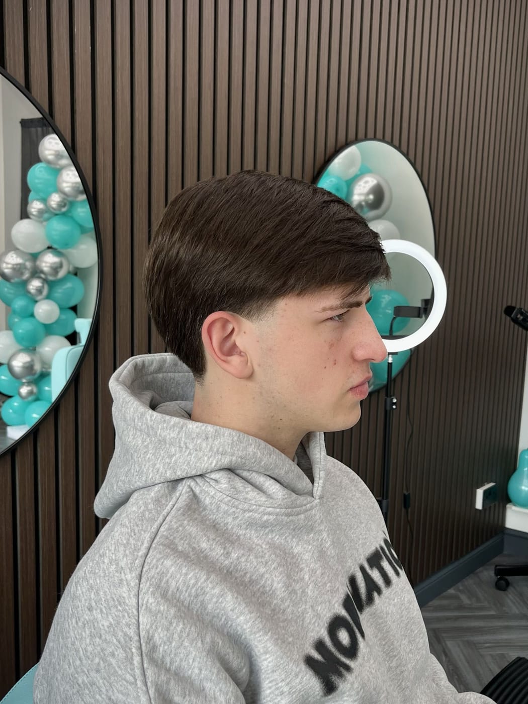 A young lad's classic middle-part cut with a taper fade at Image Barberz