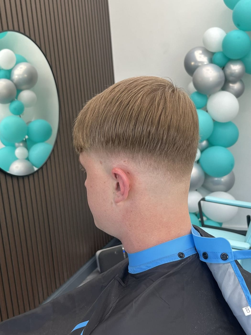 A crop with a high skin fade, freshly cut at Image Barberz